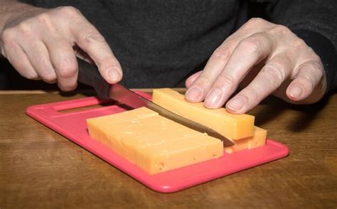 premium photo close   man cutting cheese  table