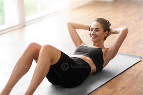 Home Training. Sporty Smiling Woman Exercising Doing Sit-Ups Abs