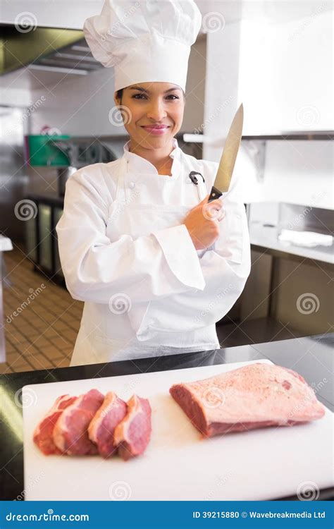 Smiling Female Chef Cutting Meat In Kitchen Stock Photo - Image: 39215880