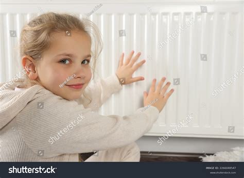 girl warming hands  heating stock photo