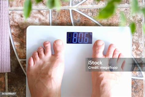 man stands  scales  scales figure  kilograms stock photo