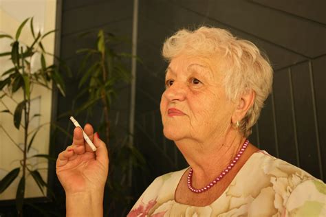 An older woman smoking a cigarette · Free Stock Photo