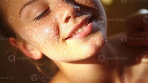 Closeup of a teenager exfoliating their skin with a gentle scrub