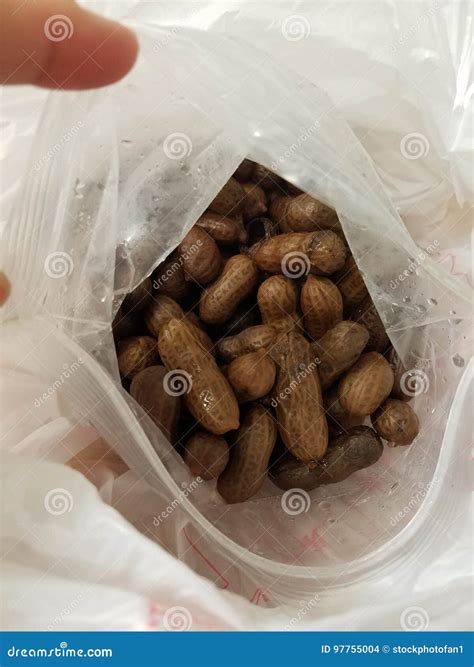 Boiled Peanuts In Wooden Cup On Crumpled Paper Stock Photo