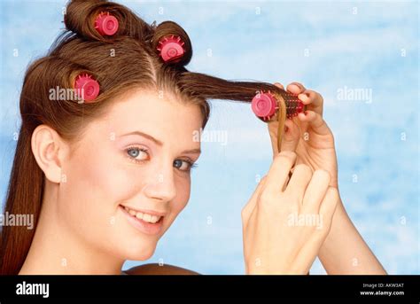 girl putting hair curlers stock photo alamy