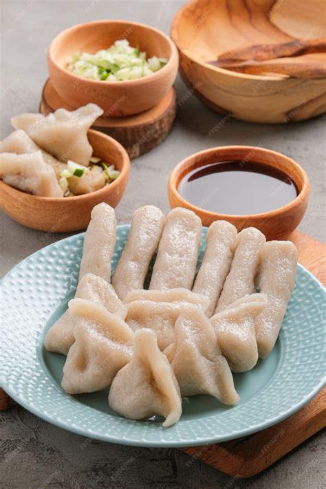 Premium Photo | Pempek served on grey unfinished cement table. Pempek ...