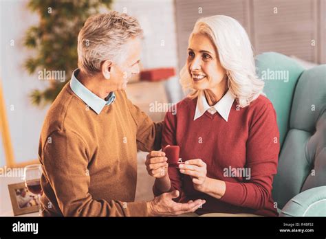 Caring husband. Caring elderly husband feeling respected while hugging ...