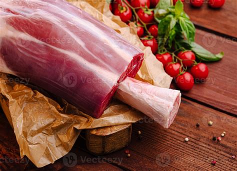Fresh cut meat with cherry tomatoes and basil on wooden table 56804621