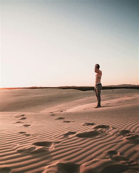 Photo of Topless Man Standing on Desert · Free Stock Photo