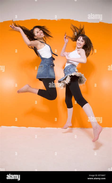 Two women jumping Stock Photo - Alamy