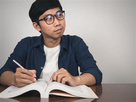 premium photo asian man wear glasses studying  gentle smile