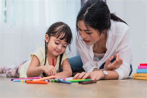 Mom teaching her daughter to drawing in art class. Back to school and