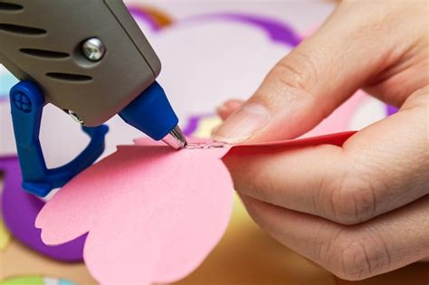 Premium Photo | Woman uses hot melt glue gun in handmade applications