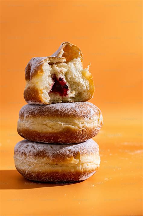 A stack of doughnuts sitting on top of each other photo – Doughnuts