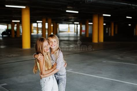 Two Beautiful Girls Having Fun and Playing in the Parking Lot Stock ...