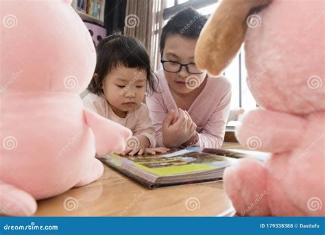 Kids Reading Book Together with Dolls Stock Photo - Image of education ...