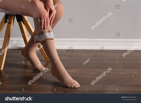 Woman Putting On Lymphedema Compression Stockings Stock Photo ...