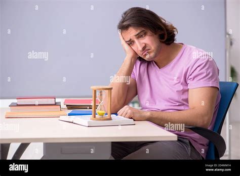 Young student in the classroom at time management concept Stock Photo ...