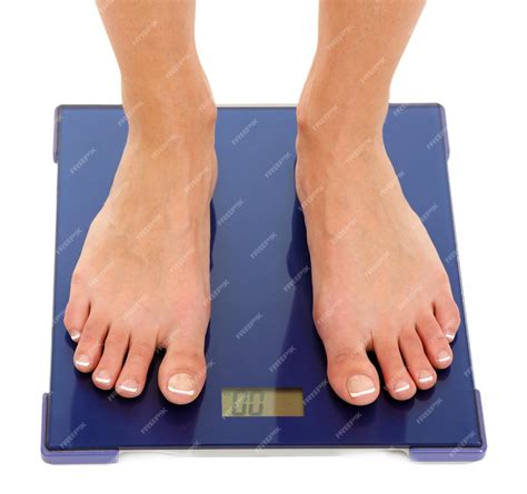 premium photo bare female feet standing  scale isolated  white