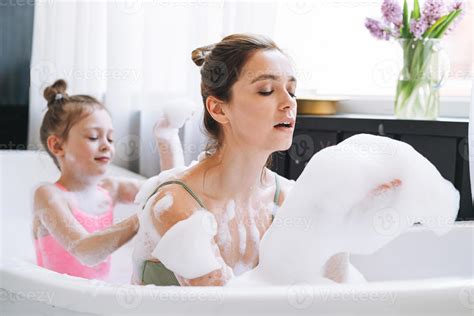 Young mother woman and little tween girl daughter having fun in the