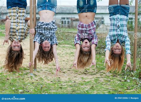 Four Young Girls Hanging Upside Down in Park Stock Photo - Image of ...