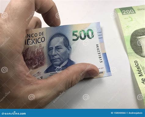 Mexican Peso Bills Spread Randomly Over a Flat Surface with a Hand Over ...