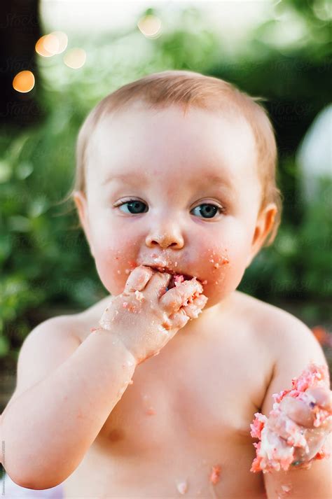 "Baby Eating A Pink Cake With Her Bare Hands" by Stocksy Contributor