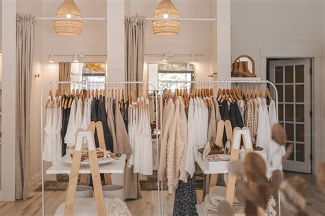 A clothing rack with clothes hanging on it photo – Shop Image on Unsplash