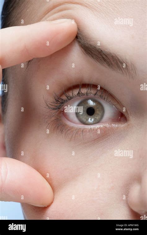 woman holding  eye open close  stock photo alamy