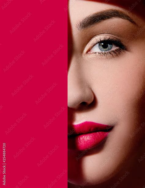 Plump bright red lips in red paper frame. Young model face. Close up ...