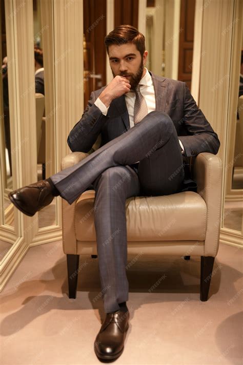 photo vertical image  man sitting  armchair