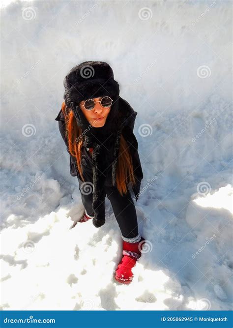 Beautiful Redhead Woman on Fashion Winter Outfit Surrounded by Snow in