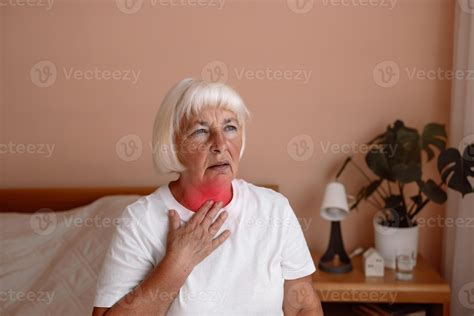 Heart attack. Sick senior adult elderly woman touching the neck feeling