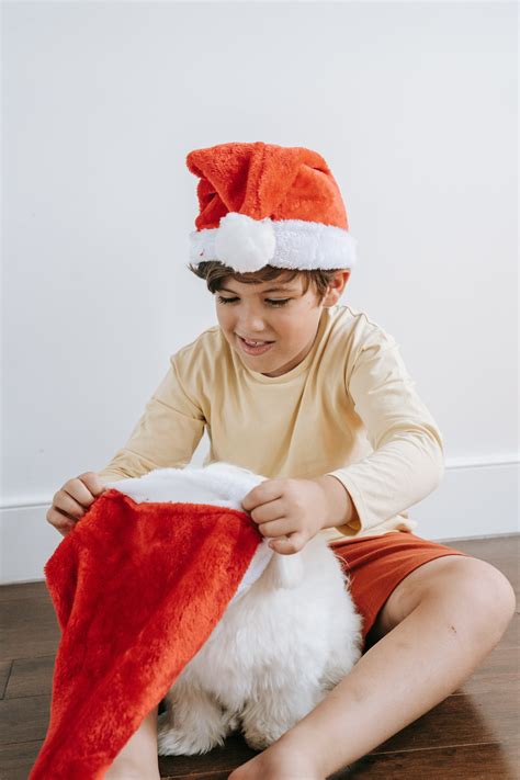 Photo of a Happy Family Sitting Beside the Christmas Tree with Their Dog · Free Stock Photo