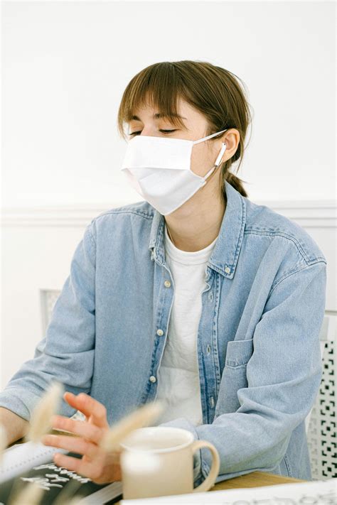 Woman in Face Mask Working at HomeFree Stock Photo