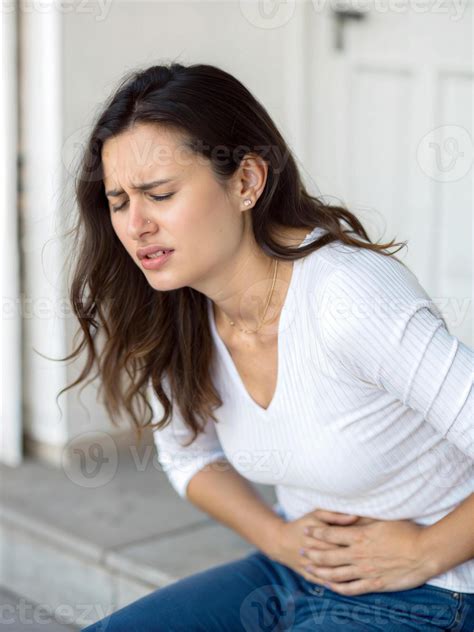 Pretty woman having sore belly, stomach pain, bellyache, feeling unwell