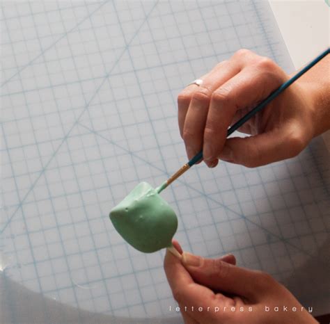 Painting any cracks on the owl cake pops - Letterpress Bakery
