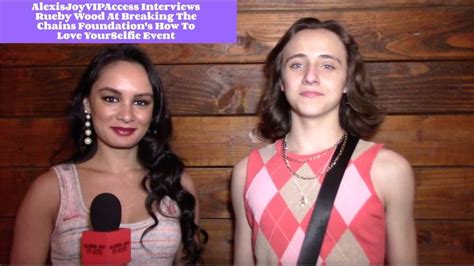 two women standing next to each other with microphones in front of them ...