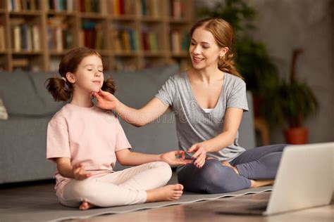 Young Happy Mother Teaching Child Meditation Techniques while Having ...