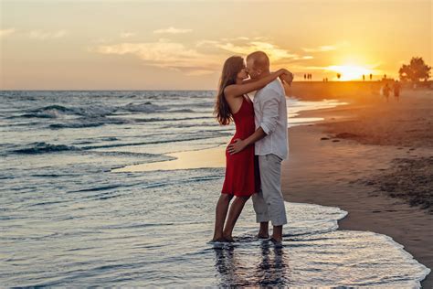 Couple Kissing on Beach during Golden Hour · Free Stock Photo