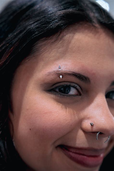 eyebrow piercings    sword tattoo
