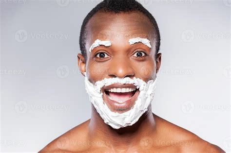 Shaving is fun. Portrait of playful African man with shaving cream