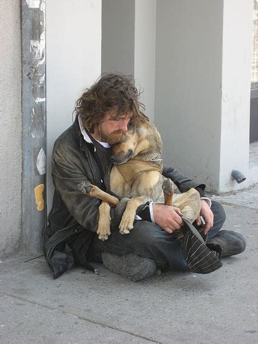 Homeless man cuddling dog | REALNEO for all