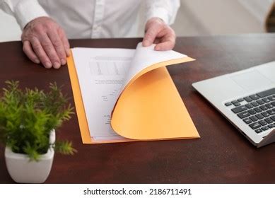 businessman opening folder paper documents stock photo
