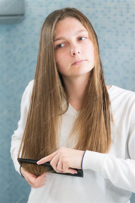 premium photo young girl brushing  hair