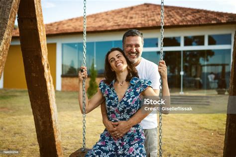 romantic couple swinging   fun outdoors stock photo