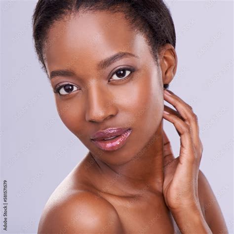 Beautiful skin and personality. an attractive young woman touching her ...
