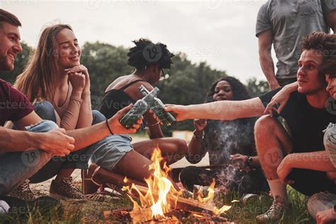 Drunk and happy. Group of people have picnic on the beach. Friends have