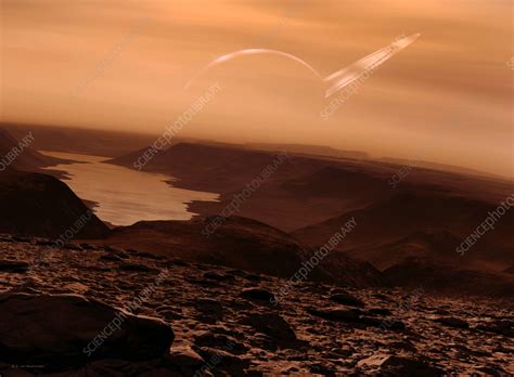 Titan surface with Saturn in sky, illustration - Stock Image - C059 ...