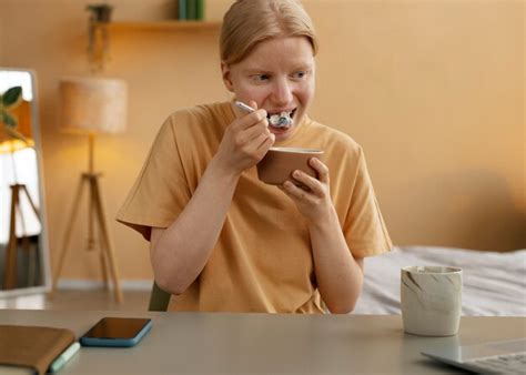 Free Photo | Medium shot albino woman having breakfast
